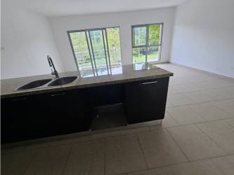 Spacious living area and kitchen with granite countertop and large windows PH Soleo Panama Pacifico