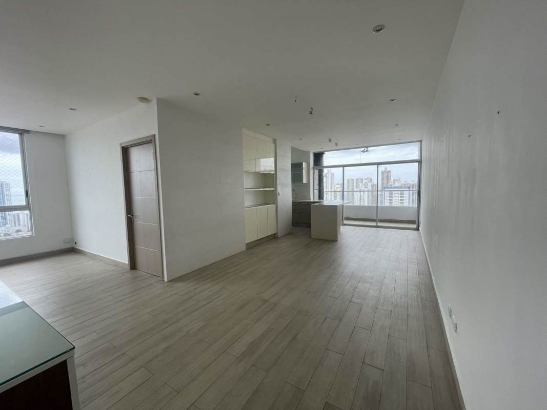 Outdoor children's play area with wooden playset, artificial grass and city skyline view at PH South Coast Panama City