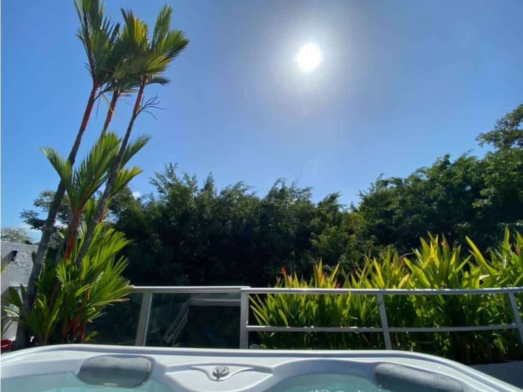 Open terrace with jacuzzi overlooking lush greenery at Clayton Hills