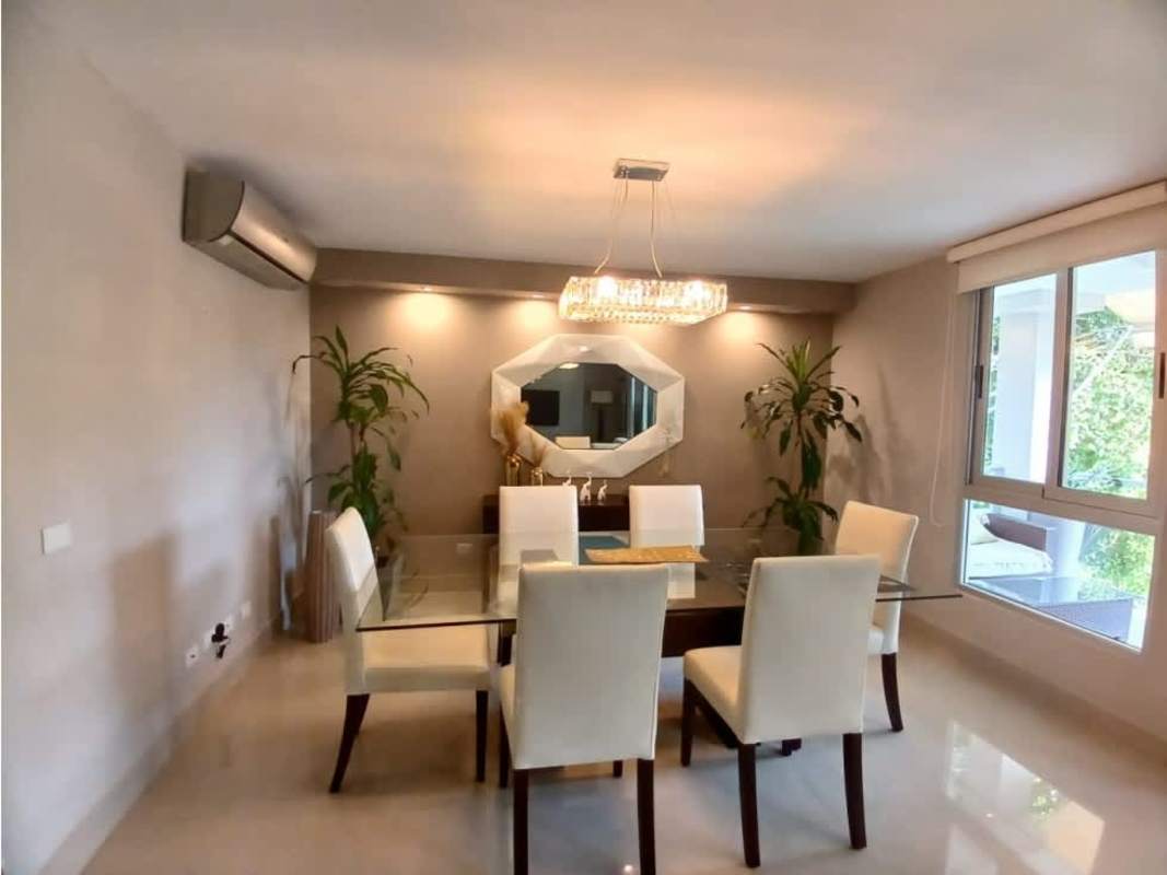 Bright dining area with glass windows and stylish chandelier in PH Clayton Hills