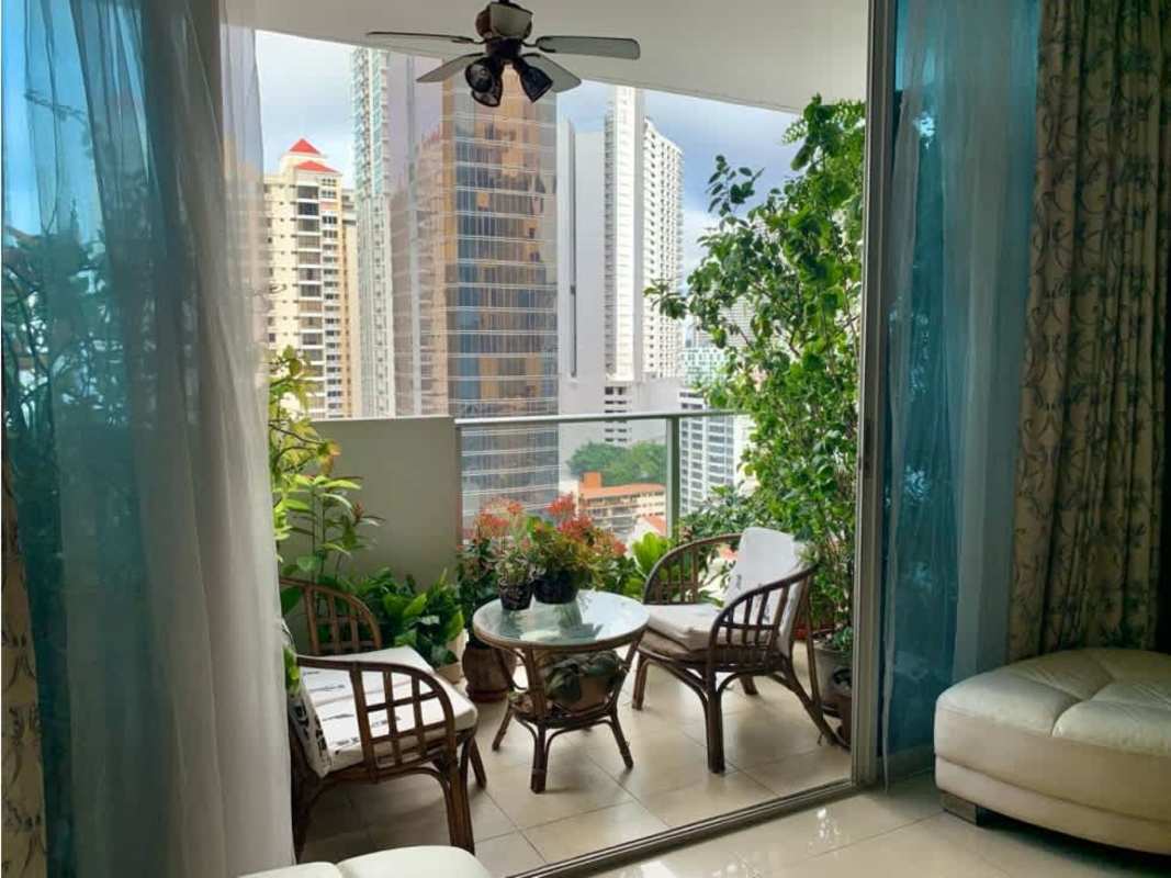 Covered balcony with glass railing and panoramic city skyline in PH The Palm Obarrio