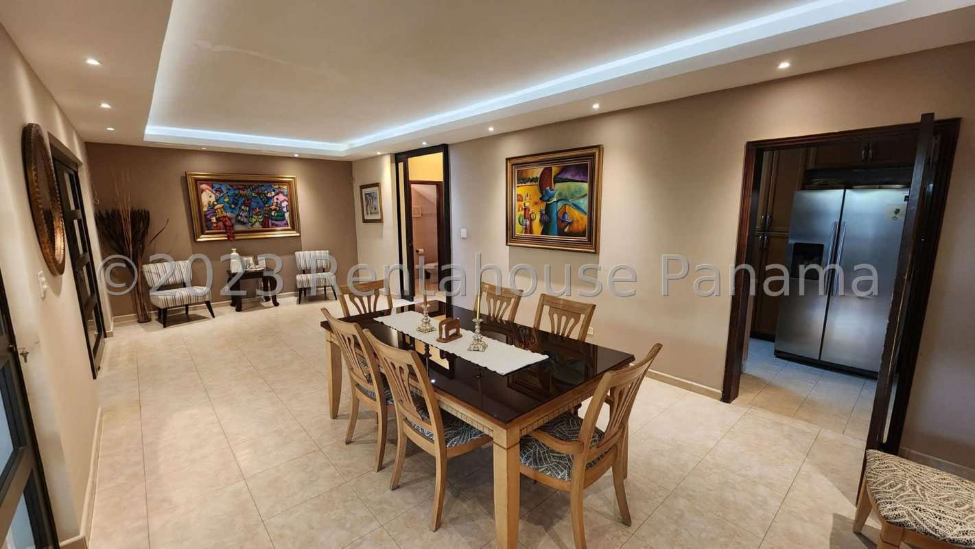 Large dining room with glass table, sliding doors and modern finishes in PH Palmeras del Este Panama City