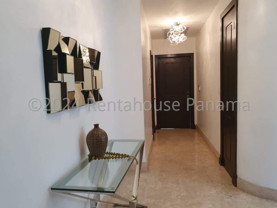 Modern dining area with glass table, chandeliers, marble floors in luxury Costa del Este house