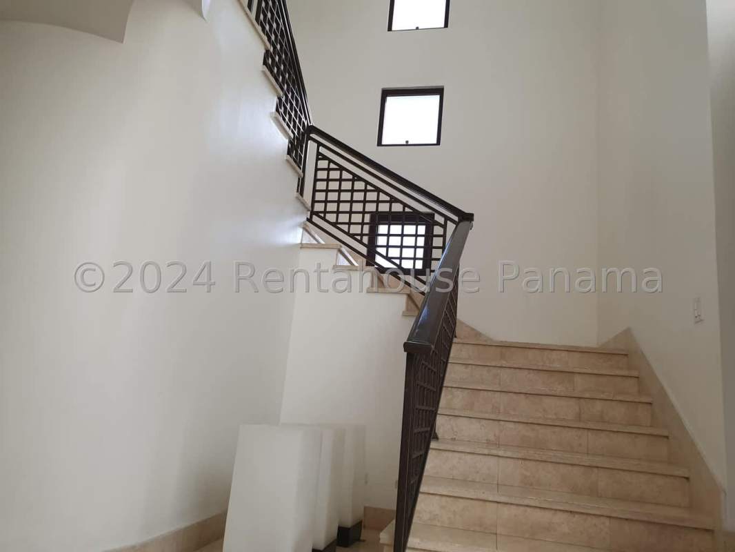 Elegant modern living room with chandelier, marble floors, tall windows in PH Paseo del Parque Costa del Este