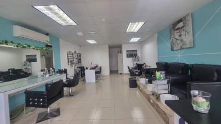 Salon interior with styling stations large mirrors reception and modern furnishings in commercial unit Panama Oeste