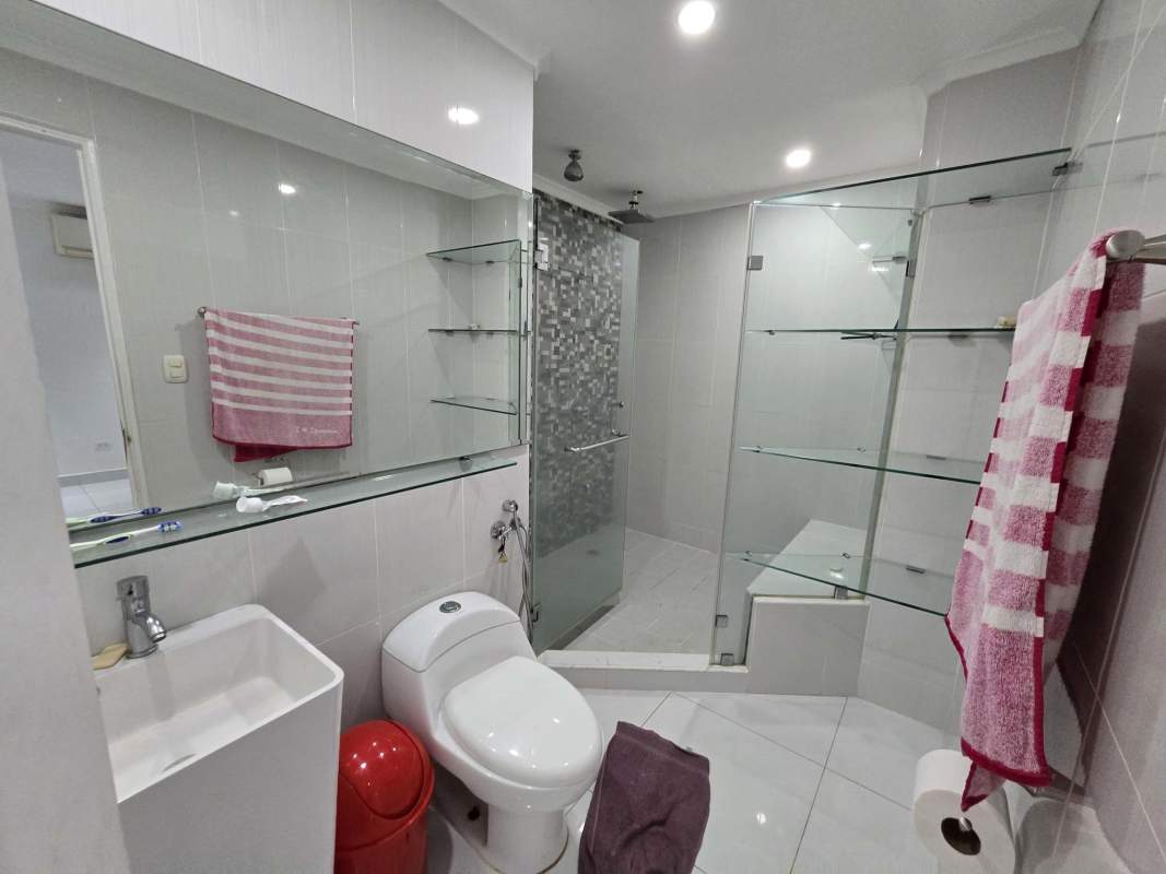 Bright modern bathroom with ceramic tiles, glass shower in Brisas del Golf house for rent