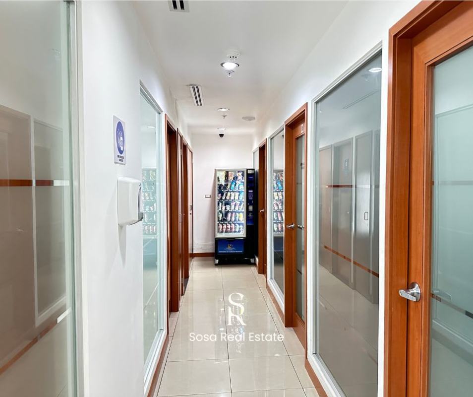 Glass-doored corridor with vending machine inside PH Molon Tower office floor Panama City
