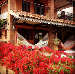 Spanish Colonial porch with brick columns, hammocks, flowers La Pintada Penonomé