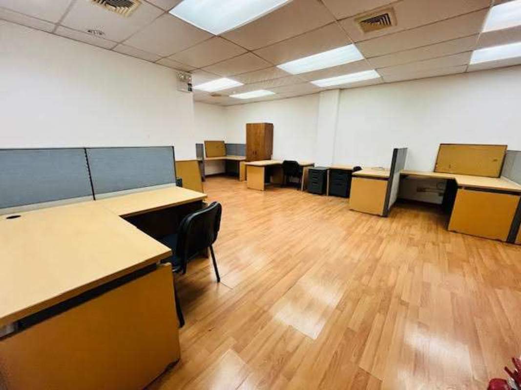 Office space with work desk stations and fluorescent lights at Boulevard Balboa Panama