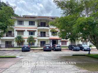 Three-story condo building with balconies, parking, lush landscaping in PH Valle del Río Boquete Panama