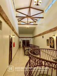 Mediterranean style hallway with iron railing and chandeliers at PH Valle del Río Boquete