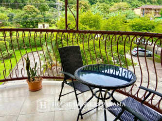Balcony with seating, iron railing overlooking lush mountains at PH Valle del Río Boquete