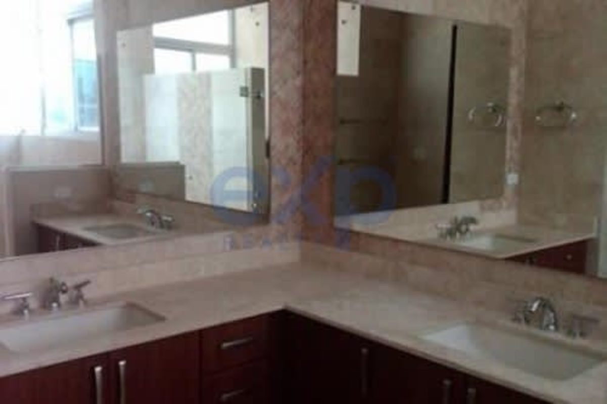Elegant bathroom with marble double sinks and wood cabinets PH Terrazas del Pacífico Panama