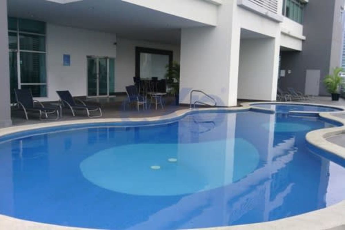 Infinity pool with lounge chairs luxury apartment PH Terrazas del Pacífico Panama City