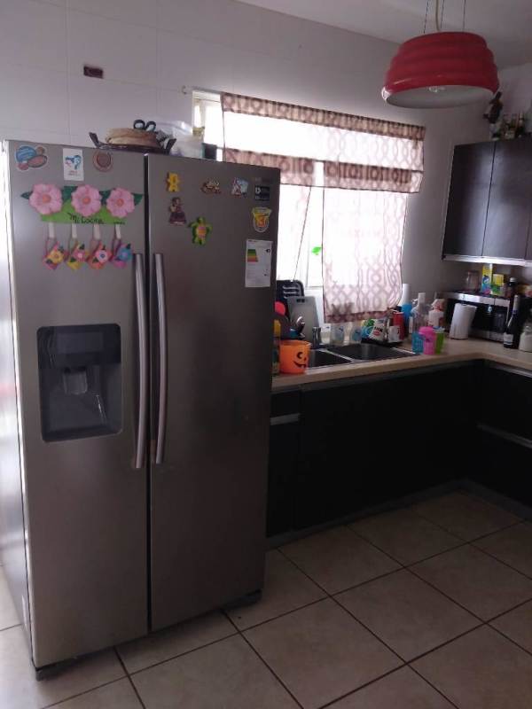 Spacious living room with large window, tile floor in Alphes townhouse Panama City