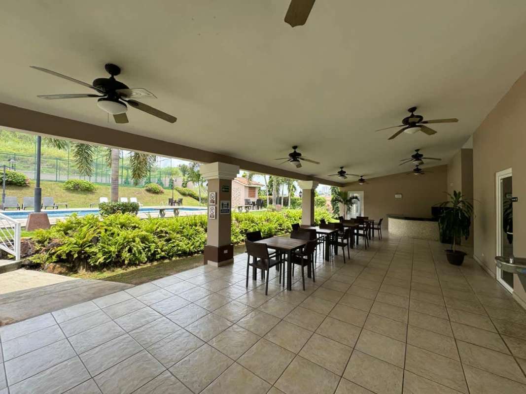 Spacious covered terrace opening to fenced backyard family home Brisas del Golf Panama