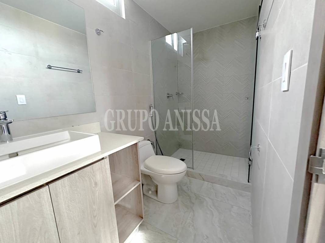 Modern bathroom with glass-enclosed walk-in shower and vanity in PH Luxor Tower Panama City