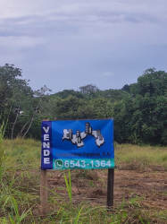 Vacant commercial lot along Panamerican Highway Rio Hato with signage and utilities.