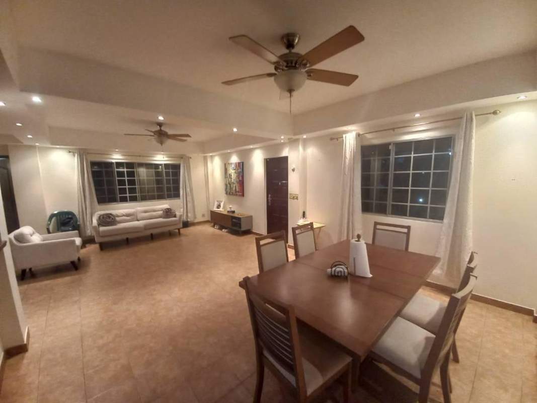 Living and dining areas with neutral decor, large windows, and tile flooring in Albrook house for rent