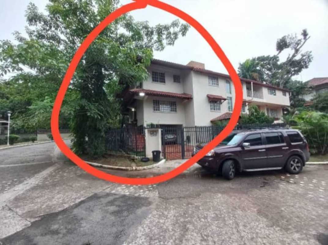 Two-story Mediterranean-style house with tile roof, fenced yard and driveway in Albrook Panama