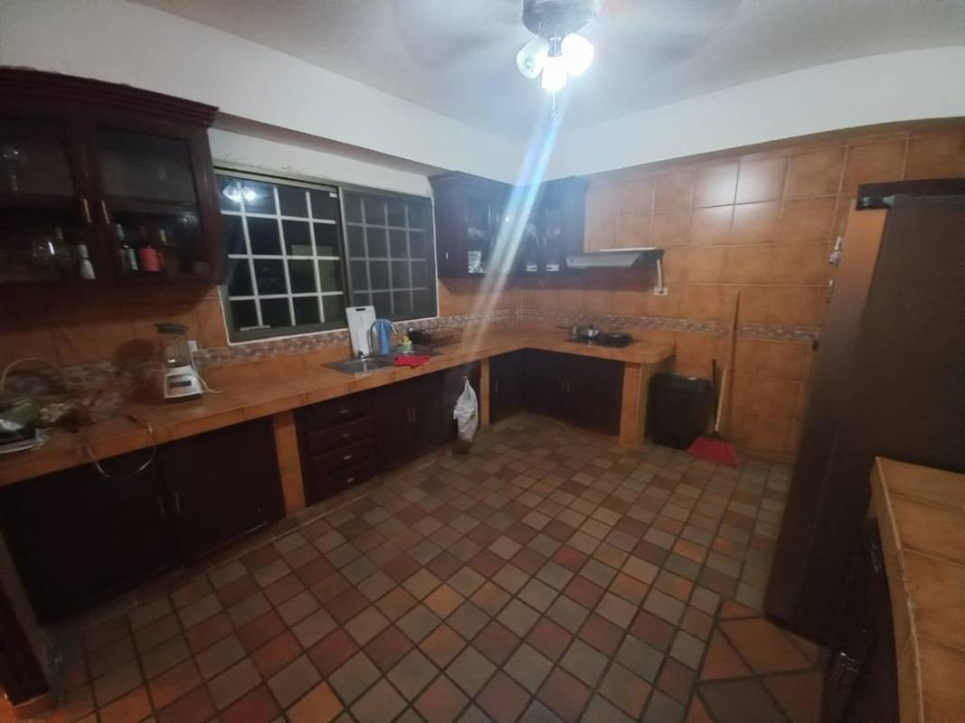 Traditional large kitchen with wooden cabinets and ceramic tile countertops in Albrook house
