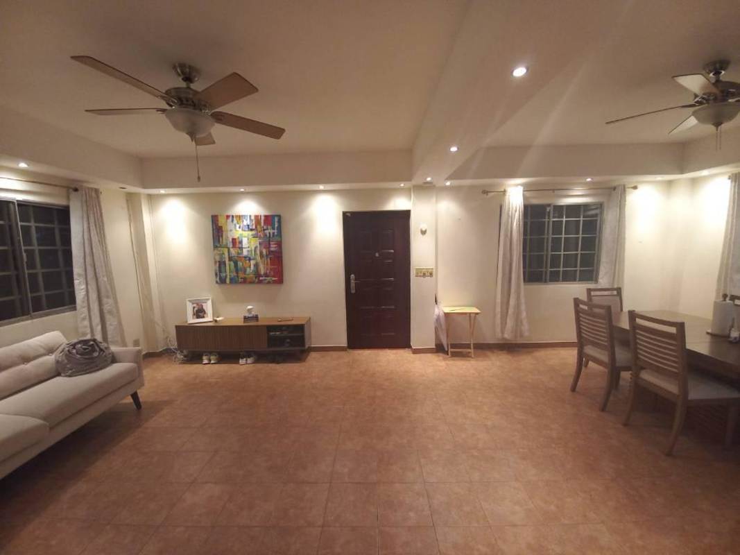 Open plan tiled living and dining room with ceiling fans in Albrook Panama rental house
