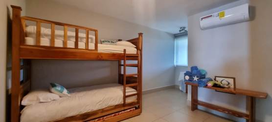 Children's or guest bedroom with bunk bed and AC PH Royal Pacific beachfront condo Panama