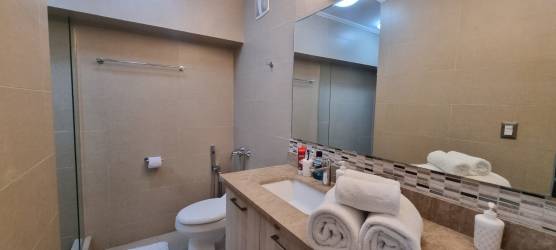 Master bedroom with large windows, balcony access and ocean view in PH Royal Pacific Panama