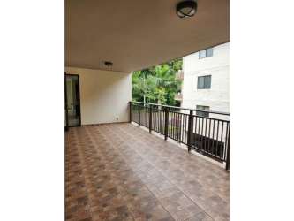 Covered balcony terrace with tiled floors and metal railing in PH River Valley Panama apartment