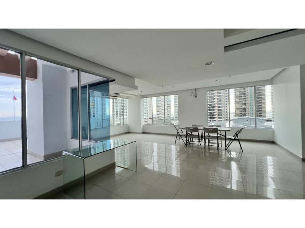 Bright dining space with floor-to-ceiling windows overlooking ocean skyline in PH Waterview