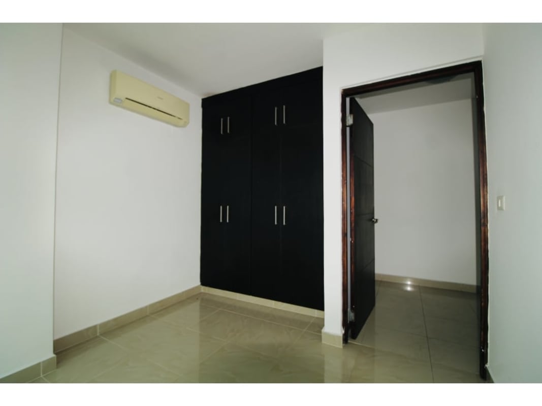 Enclosed kitchen with granite countertops, dark cabinetry, double sink and tiled backsplash in PH Waterview