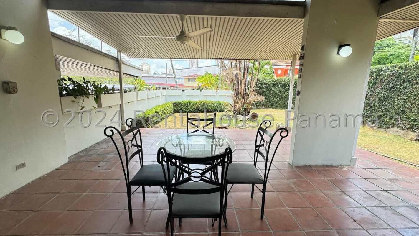 Covered terrace overlooking tropical fenced garden Villa Lilla San Francisco Panama
