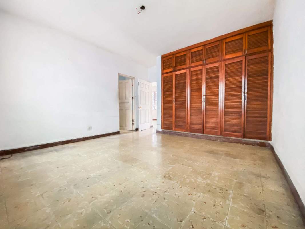 Bedroom with wooden wardrobes and tiled floor in PH My Boy Panama