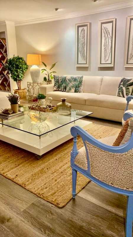 Living room with cream sofa, plants and wall art in La Alameda Villa de las Fuentes Panama City