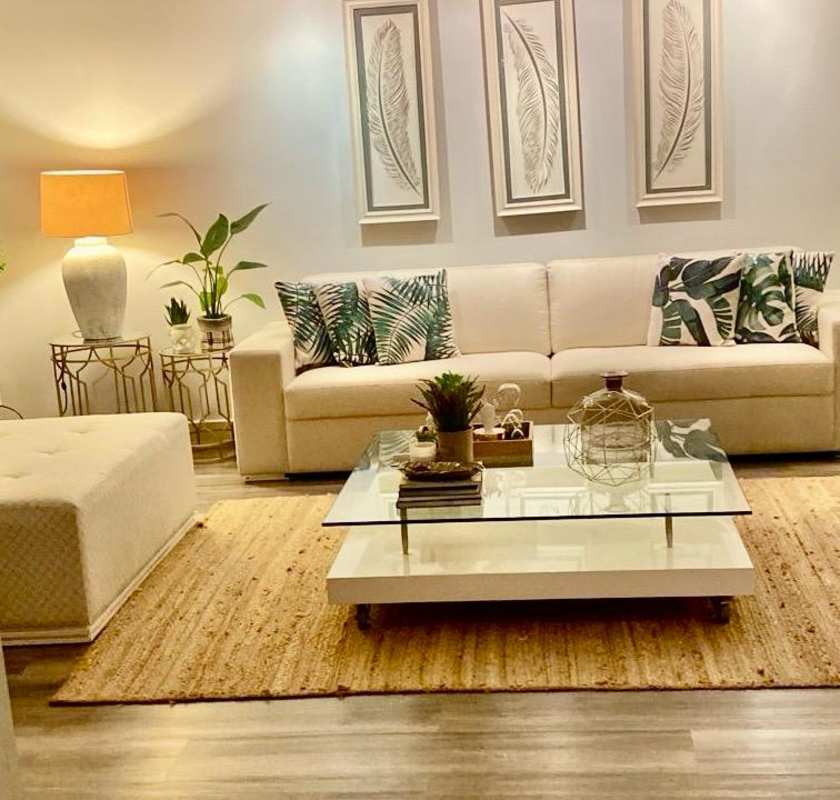White sectional sofa, red Asian-style cabinet and potted plants in house Villa de las Fuentes La Alameda