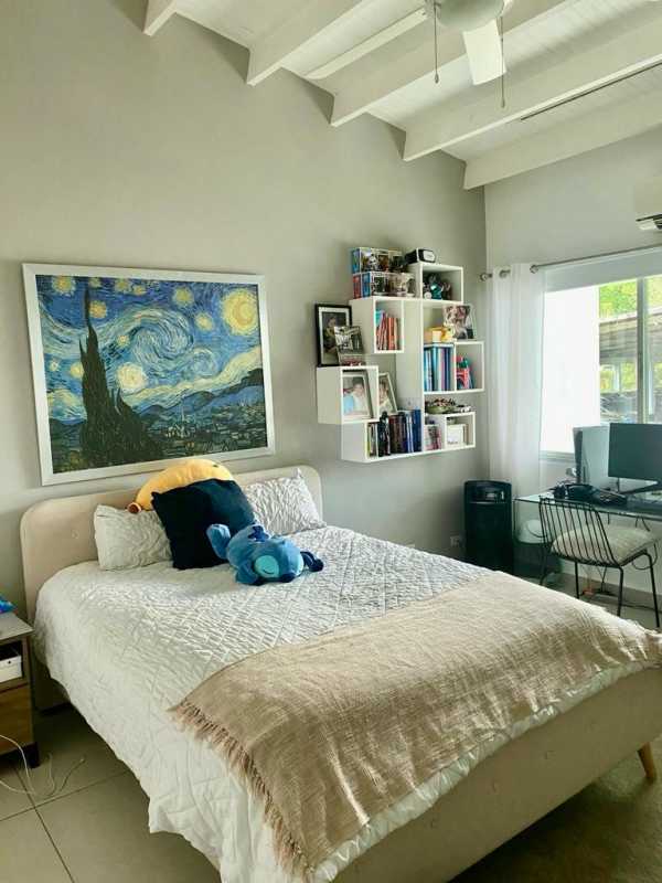 Tropical garden with lawn, bench, and plants in backyard Villa de las Fuentes Panama