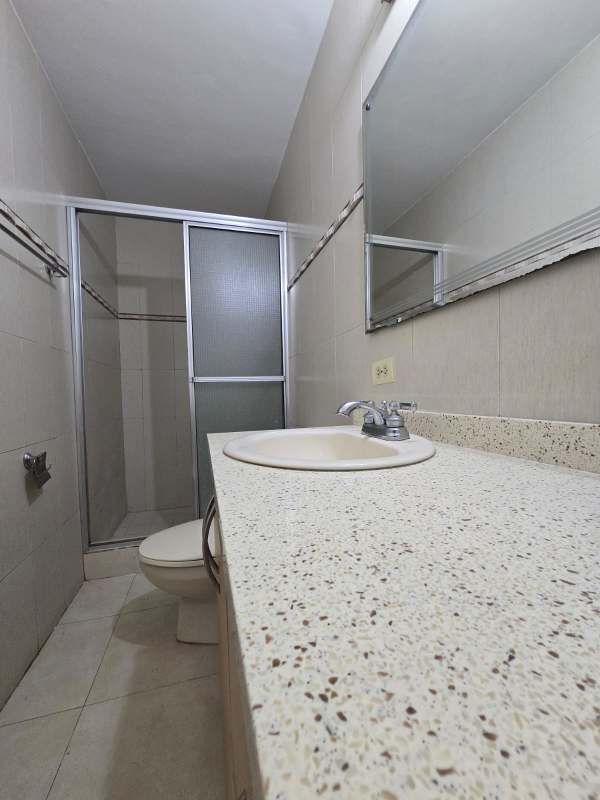 Modern kitchen with granite counters, wooden cabinets, double stainless sink in PH Aranjuez El Cangrejo Panama