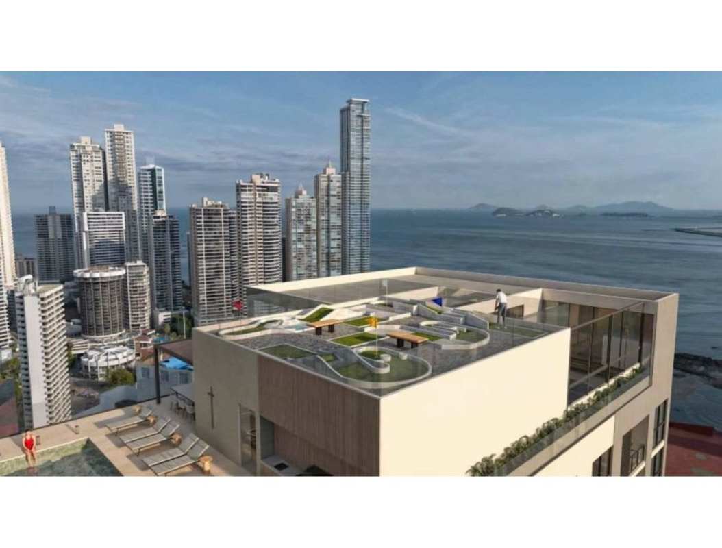 Contemporary rooftop garden lounge area with ocean and skyline views in PH Moderna Panama City