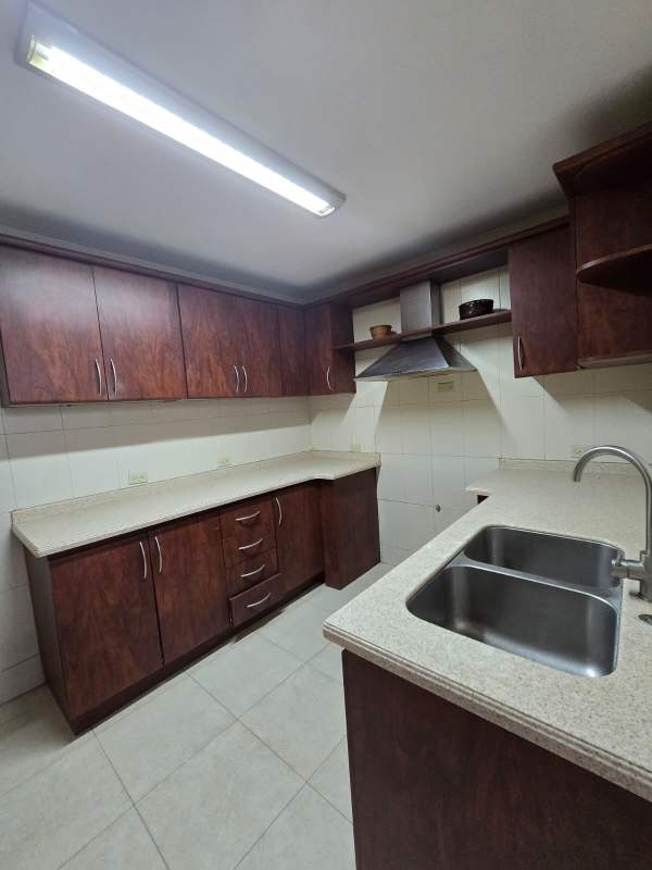 Contemporary kitchen with granite countertops and wooden cabinets PH Aranjuez Via Argentina