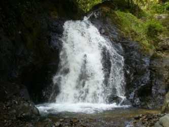 Scenic private waterfall cascading over rocks surrounded by greenery in Soná Veraguas Panama