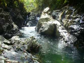Clear stream with rocky pool in lush Panamanian countryside Soná Veraguas