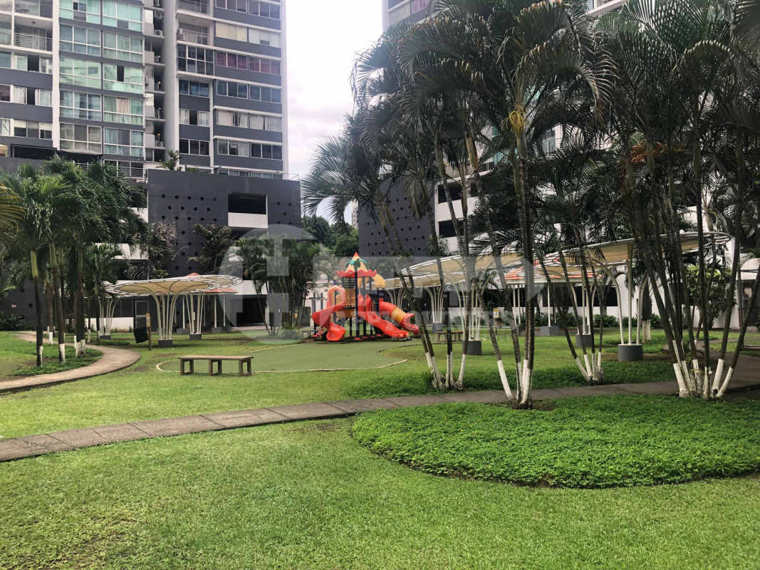 Landscaped condominium grounds with children’s playground, palm trees and pathways PH Central Park Panama