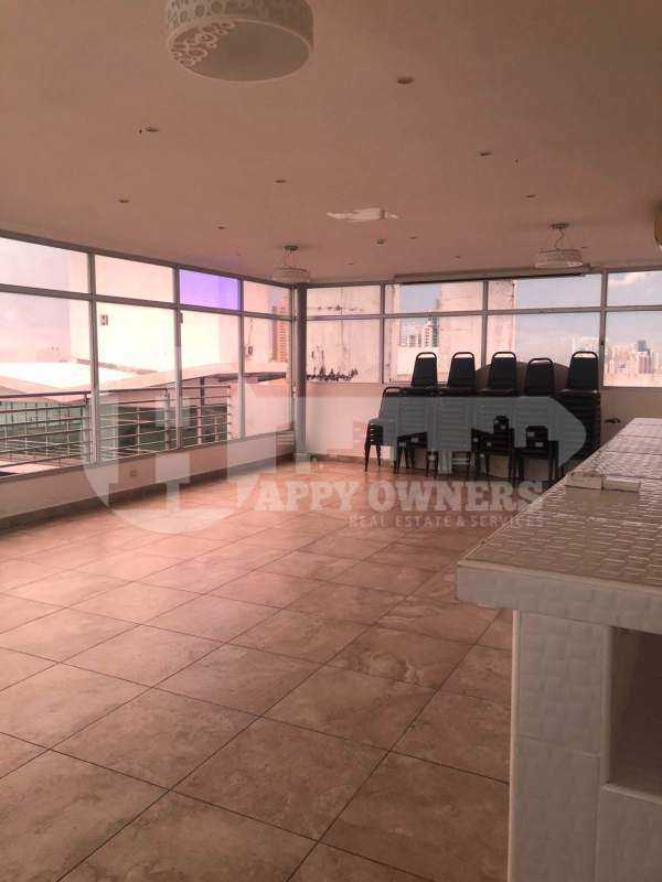 Spacious rooftop lounge or multipurpose hall with windows and bar in PH Central Park Panama