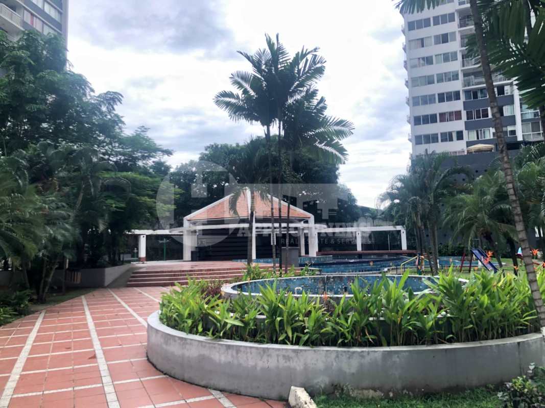 Swimming pool surrounded by gardens, gazebo and buildings in PH Central Park Panama