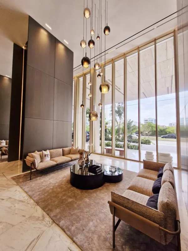Elegant lobby with floor-to-ceiling windows, marble and designer furnishings at La Maison by Fendi