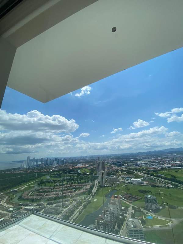 Modern bathroom with marble finishes, large window with scenic ocean and golf views at La Maison Fendi Panama