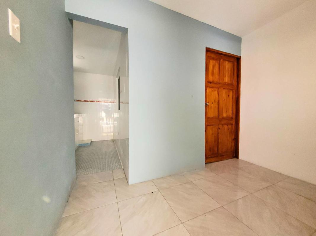 Spacious bedroom with security bars, closet space, tiled floors at investment property San Francisco Panama