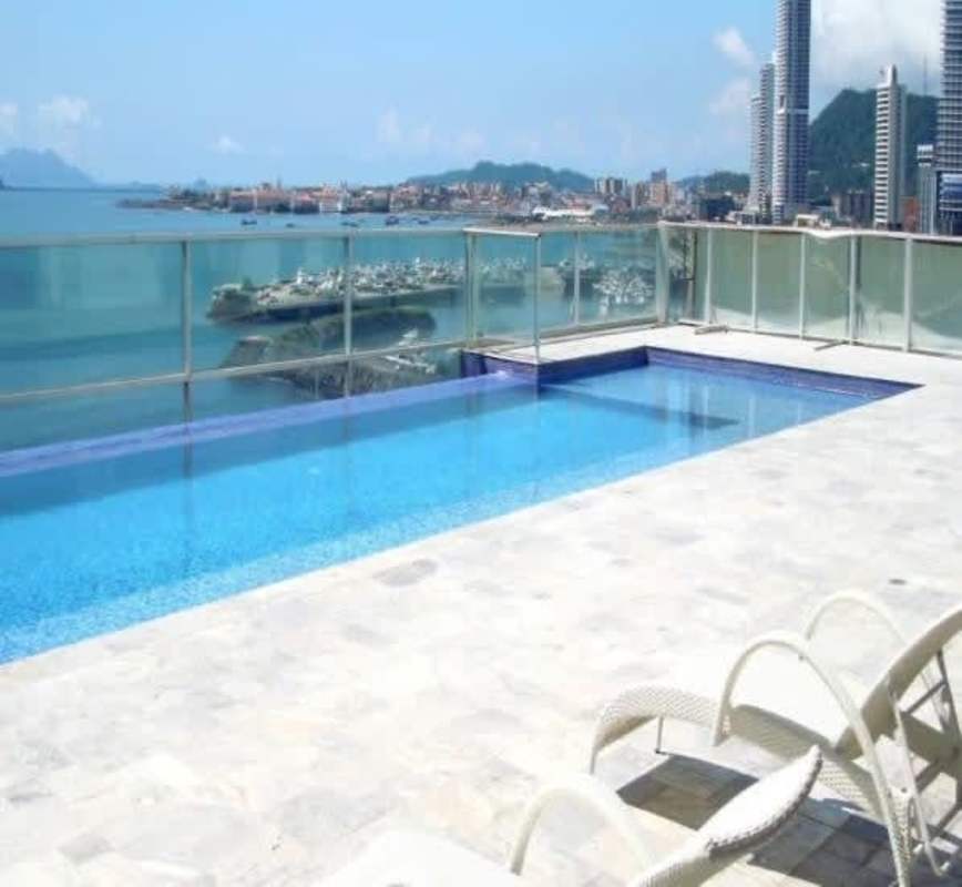 Spacious living dining area with tile floors and skyline views PH Waters on the Bay Panama