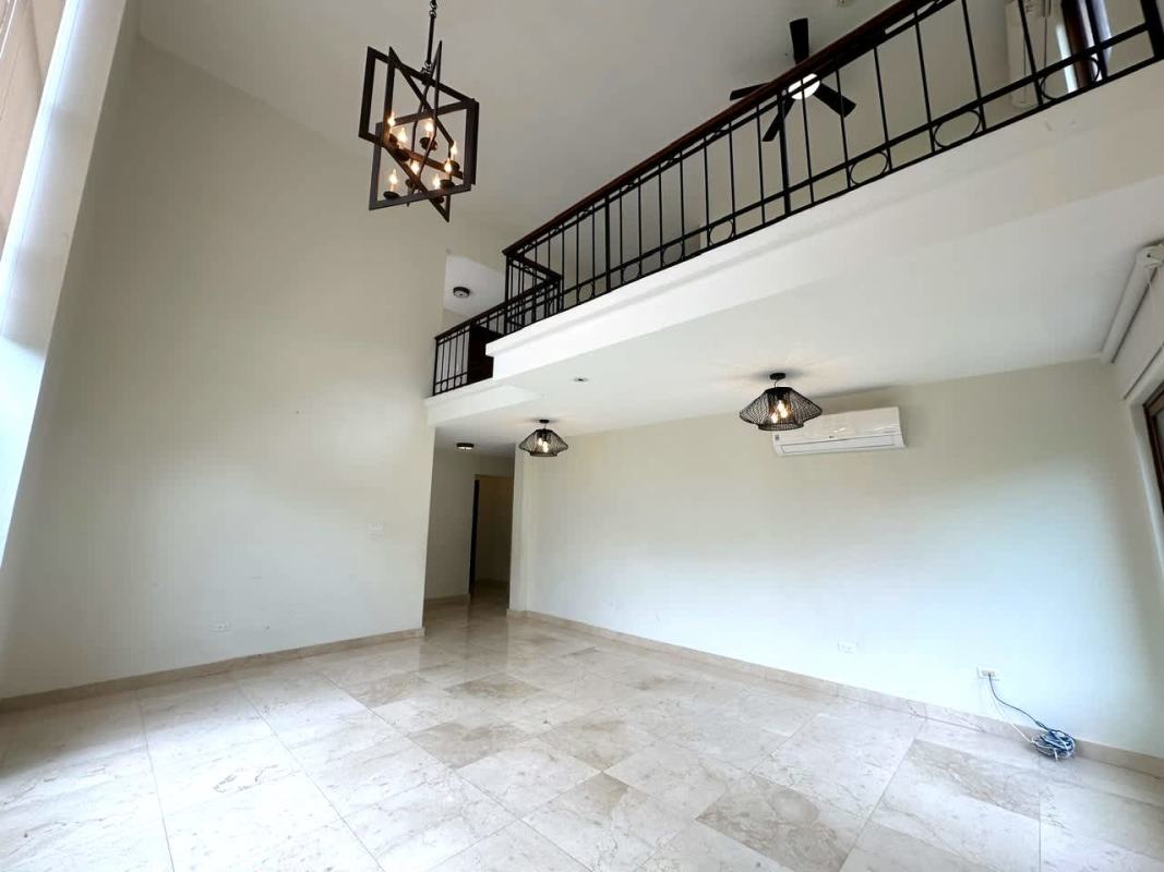 Living area with high vaulted ceilings and loft in Clayton Panama luxury home