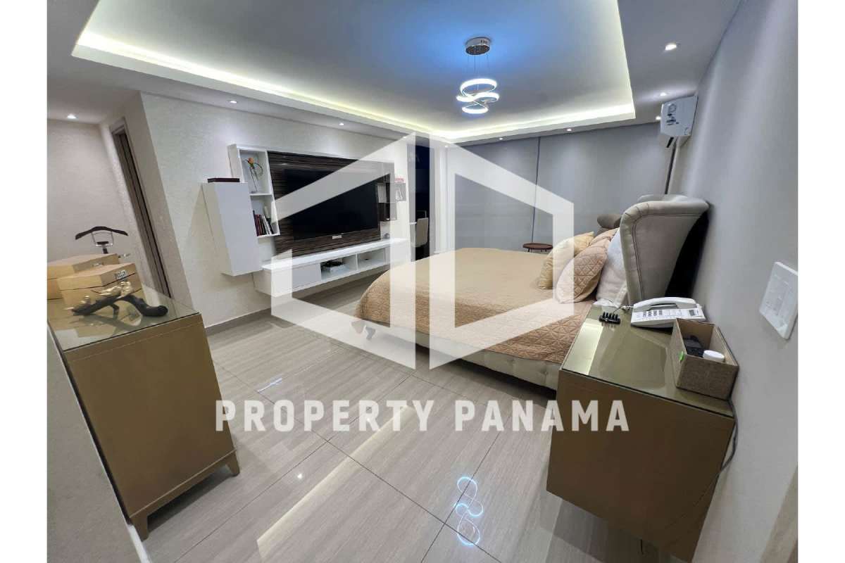 Spacious bedroom with TV, minimalist decor and custom cabinetry PH Mar de Plata Panama City